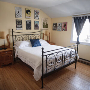 Black Sheep - view of bed, posters on wall, night stands, and window