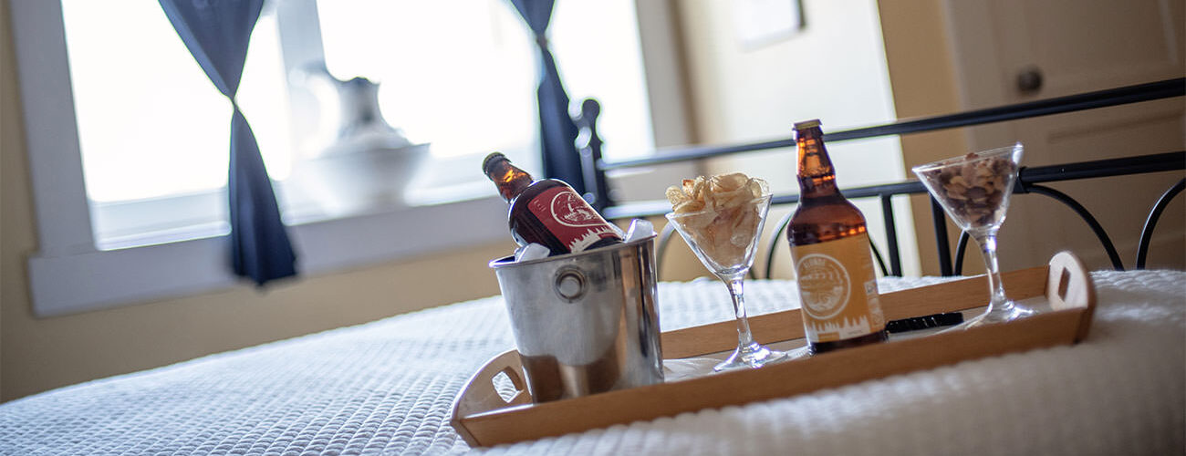 Drinks on bed tray with ice bucket